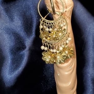 Silver hooped earrings with 2D flowers and pearls.